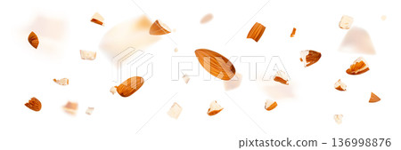 Crushed almonds falling isolated, flying nut pieces, levitate scattered almond seeds 136998876