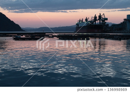Fishing port illuminated by the setting sun Fishing port illuminated by the setting sun 136998989
