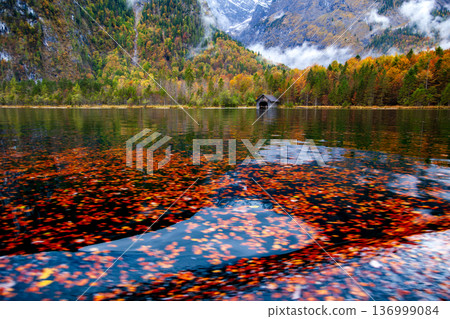 Autumn scenery of Königssee in Germany and the tranquil wooden boat docks along its shore. Autumn scenery of Königssee in Germany and the tranquil wooden boat docks along its shore. 136999084