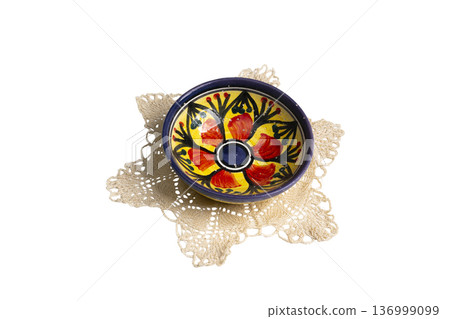 a small hand-painted bowl on a crocheted doily a small hand-painted bowl on a crocheted doily 136999099