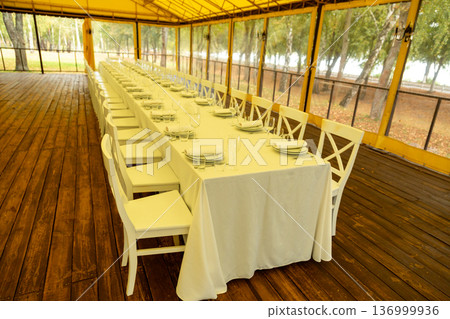 Long banquet table in event tent Long banquet table in event tent 136999936