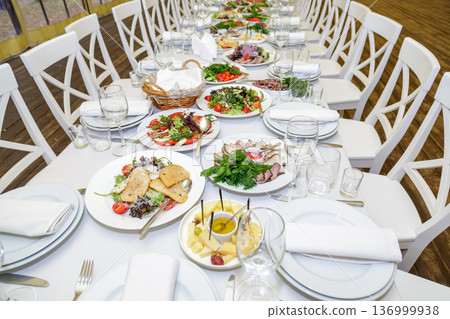 Festive table setting with salads and dishes 136999938