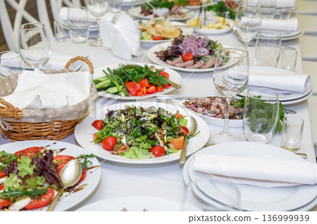Festive table setting with salads and dishes Festive table setting with salads and dishes 136999939