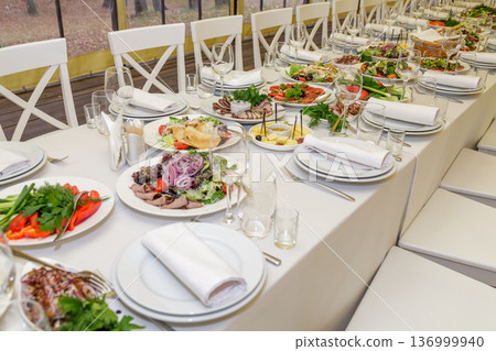Festive table setting with salads and dishes Festive table setting with salads and dishes 136999940