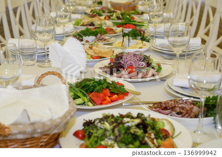Festive table setting with salads and dishes Festive table setting with salads and dishes 136999942