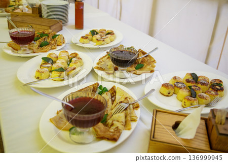 Desserts and plates on banquet table Desserts and plates on banquet table 136999945