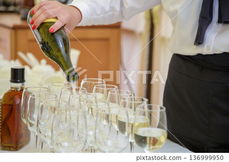 Waiter pouring wine at celebration Waiter pouring wine at celebration 136999950