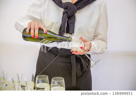 Waiter pouring wine at celebration Waiter pouring wine at celebration 136999951