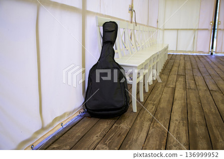 Guitar case in event tent interior Guitar case in event tent interior 136999952