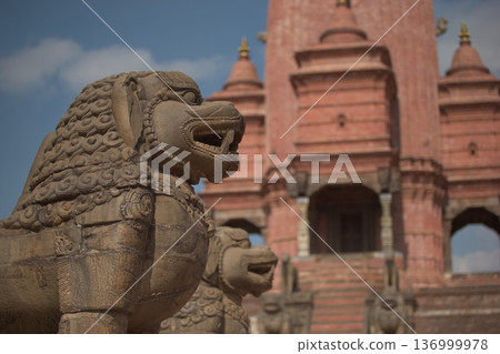 尼泊爾寺廟前的石獅雕像，背景是紅磚建築。 136999978