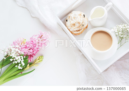 Spring morning breakfast, coffee, milk jug and cake with decor of pink hyacinth. Spring morning breakfast, coffee, milk jug and cake with decor of pink hyacinth. 137000085
