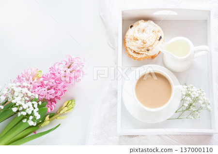 Spring morning breakfast, coffee, milk jug and cake with decor of pink hyacinth. Spring morning breakfast, coffee, milk jug and cake with decor of pink hyacinth. 137000110