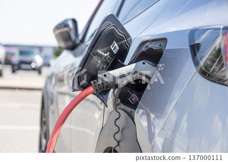 Electric car charging at station 137000111