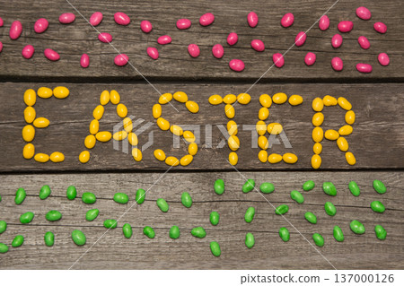 Colorful sweet candy on wooden background in text. Top view. Easter decor. Colorful sweet candy on wooden background in text. Top view. Easter decor. 137000126