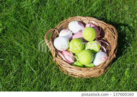 Colorful Easter eggs in basket on grass, spring festive background Colorful Easter eggs in basket on grass, spring festive background 137000160