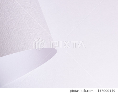 White textured paper with curved lifted sheet corner. Fine grain surface forms minimal composition. Clean background for branding. 137000419