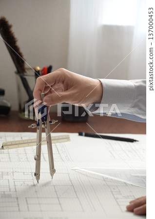 A Japanese architect drawing architectural drawings A Japanese architect drawing architectural drawings 137000453
