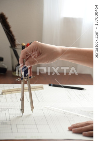 A Japanese architect drawing architectural drawings A Japanese architect drawing architectural drawings 137000454