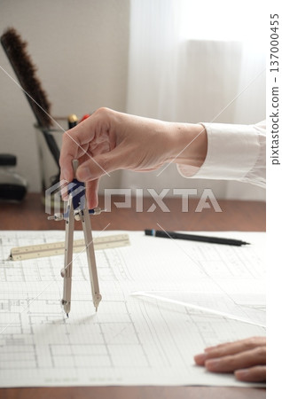 A Japanese architect drawing architectural drawings A Japanese architect drawing architectural drawings 137000455