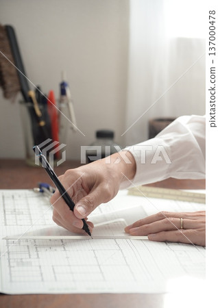 A Japanese architect drawing architectural drawings A Japanese architect drawing architectural drawings 137000478