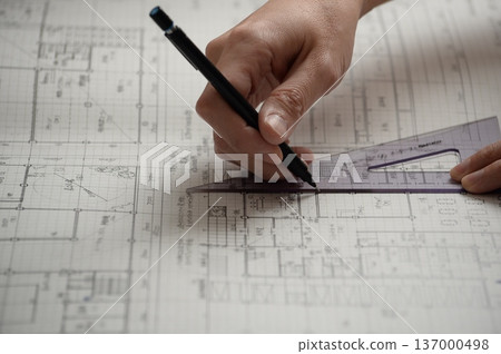 A Japanese architect drawing architectural drawings A Japanese architect drawing architectural drawings 137000498