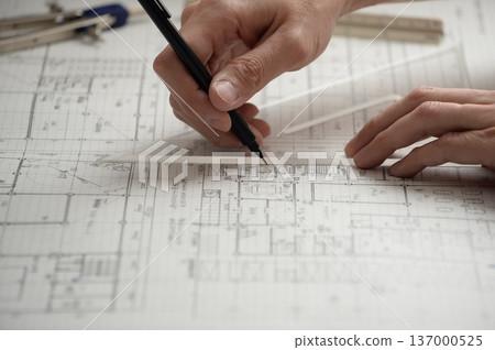 A Japanese architect drawing architectural drawings A Japanese architect drawing architectural drawings 137000525