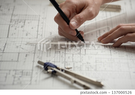 A Japanese architect drawing architectural drawings A Japanese architect drawing architectural drawings 137000526