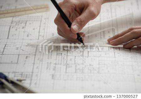 A Japanese architect drawing architectural drawings 137000527