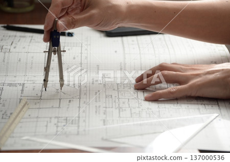 A Japanese architect drawing architectural drawings A Japanese architect drawing architectural drawings 137000536