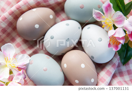 Pastel easter eggs with polka dots on gingham fabric 137001131