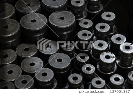 Cylindrical metal parts neatly arranged on the factory floor Cylindrical metal parts neatly arranged on the factory floor 137001587