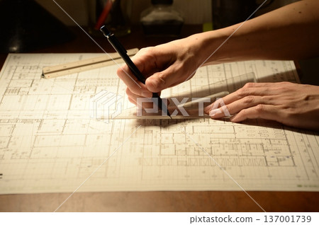 The hands of a Japanese architect drawing architectural drawings at night The hands of a Japanese architect drawing architectural drawings at night 137001739