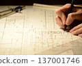 The hands of a Japanese architect drawing architectural drawings at night 137001746