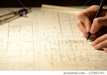 The hands of a Japanese architect drawing architectural drawings at night The hands of a Japanese architect drawing architectural drawings at night 137001747
