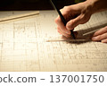 The hands of a Japanese architect drawing architectural drawings at night 137001750