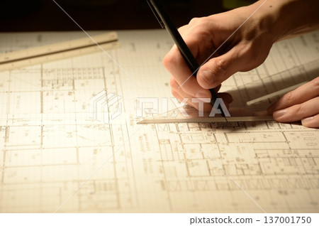 The hands of a Japanese architect drawing architectural drawings at night The hands of a Japanese architect drawing architectural drawings at night 137001750
