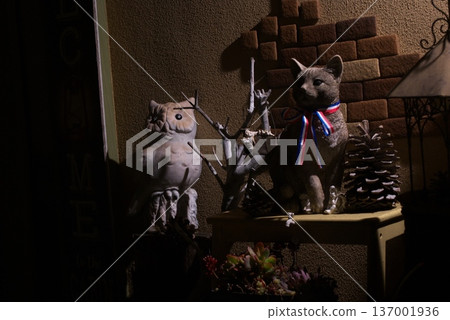 Owl and cat garden ornaments and succulents decorating the garden at night Owl and cat garden ornaments and succulents decorating the garden at night 137001936