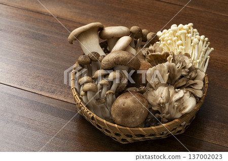 Assorted mushrooms in a colander 137002023