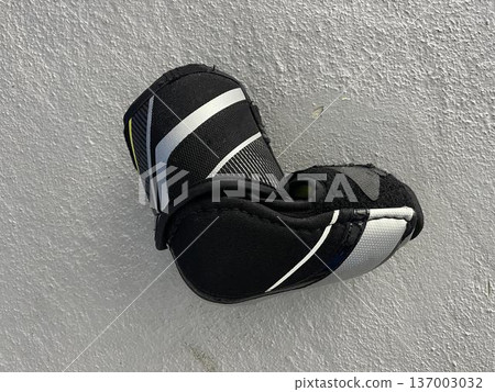 hockey arm guard isolated on gray floor hockey arm guard isolated on gray floor 137003032