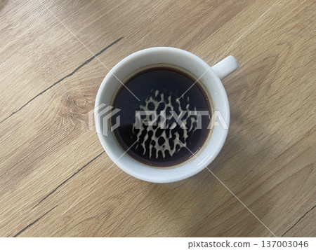 americano cup isolated on wooden table 137003046