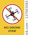 Yellow warning sign with drone prohibition symbol and bold text No Drone Zone for safety and regulation awareness 137003083