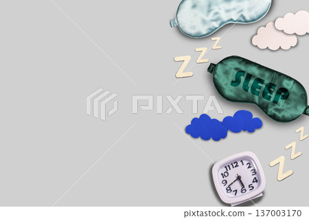 Composition of sleeping mask, alarm and clouds on colorful background. World sleep day concept Composition of sleeping mask, alarm and clouds on colorful background. World sleep day concept 137003170