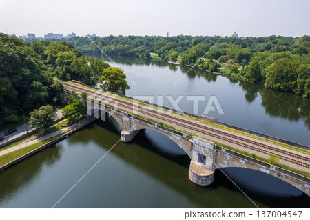 A bridge spans The schuykill river with a train track running across it 137004547