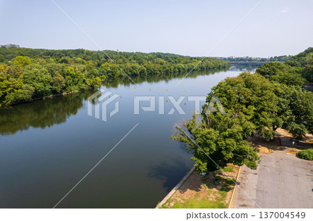 The schuykill river with a green forest on the right bank 137004549