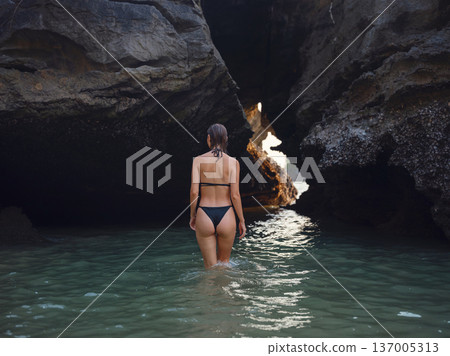 Young woman enjoying serene evening at sea in Krabi, Thailand 137005313