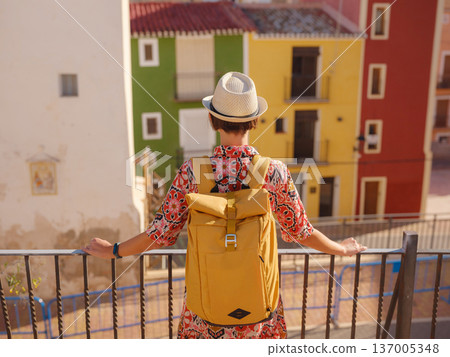 Woman strolls through colorful streets of Spanish coastal town Woman strolls through colorful streets of Spanish coastal town 137005348