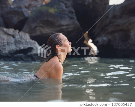 Young woman enjoying serene evening at sea in Krabi, Thailand Young woman enjoying serene evening at sea in Krabi, Thailand 137005437