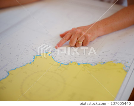 Woman Sailor Studying Navigation Map Inside Yacht Cabin Interior Woman Sailor Studying Navigation Map Inside Yacht Cabin Interior 137005440