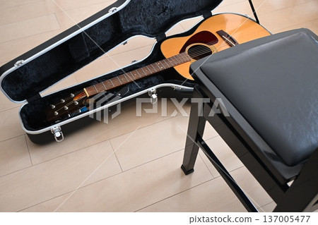 A guitar placed in the living room for practice A guitar placed in the living room for practice 137005477