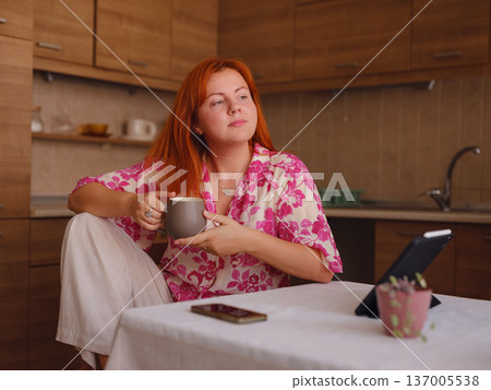 young woman working on tablet at kitchen young woman working on tablet at kitchen 137005538